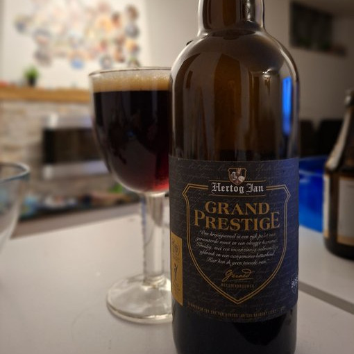 Bottle and glass of Hertog Jan Grand Prestige dark strong ale with deep brown color and tan head